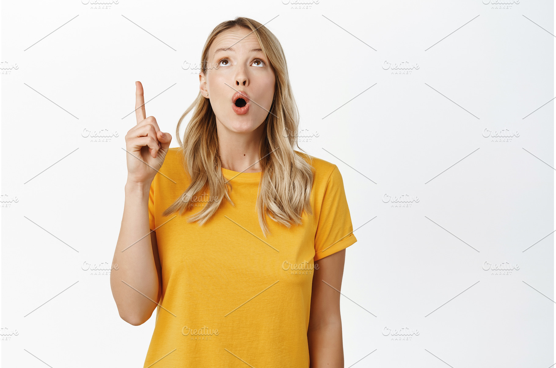 Amazed blond girl showing, a Person Photo by Cookie Studio