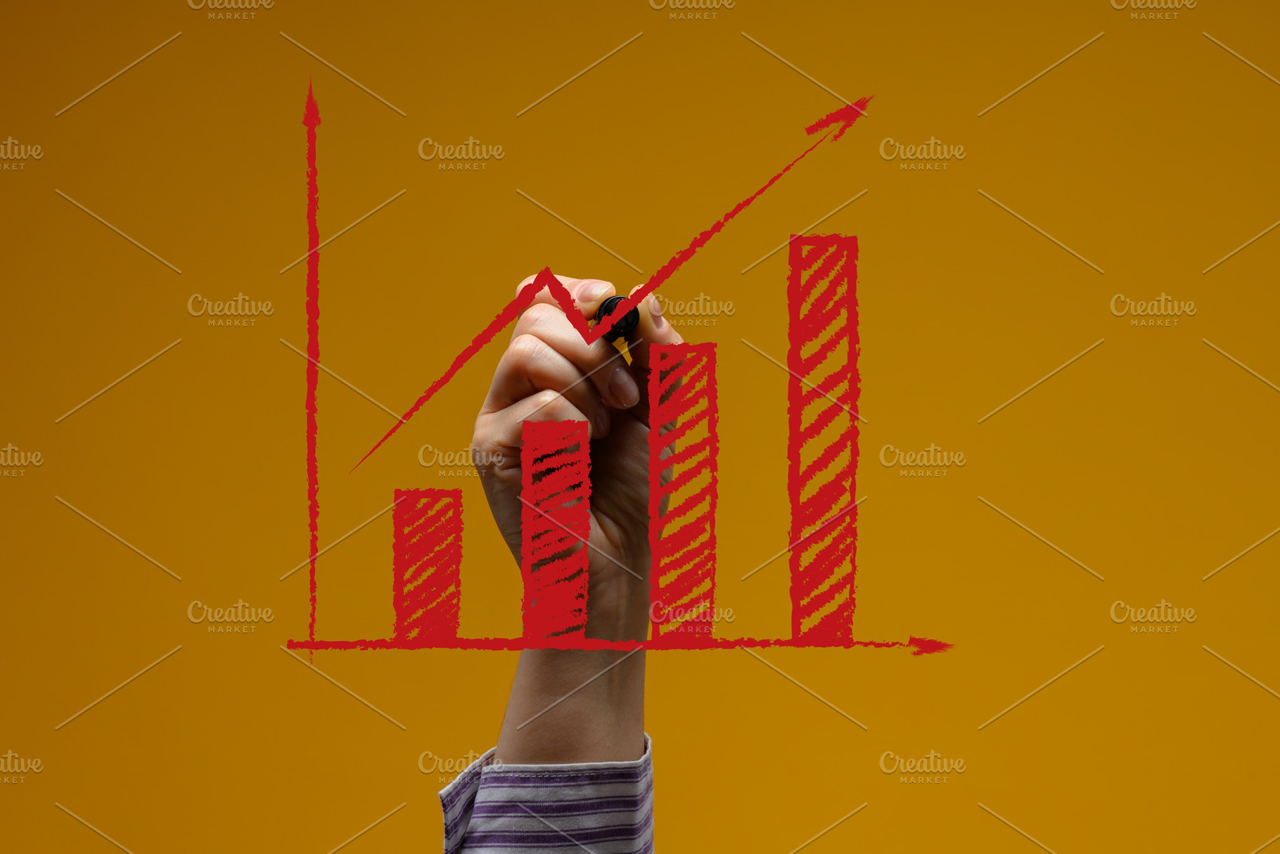 A person's hand draws a red bar graph with an upward arrow on a, a Business Photo by ndanko