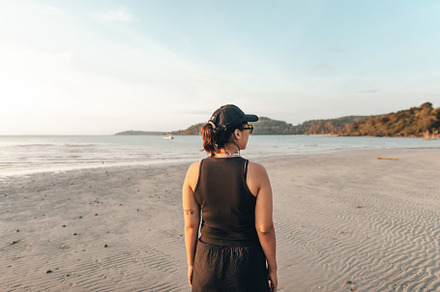 Woman walking along the beach in the evening, a Nature Photo by Art Rachen