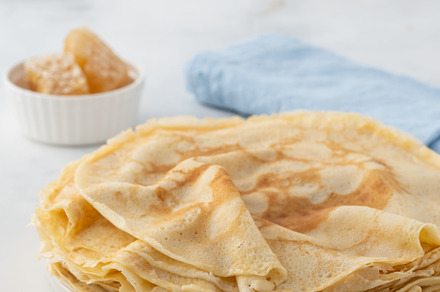 Crepes thin pancakes with honey on containing white, thin, and plate