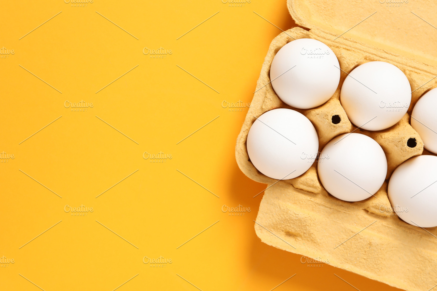 Egg box with eggs, space for text, a Food & Drink Photo by AtlasStudio PRO