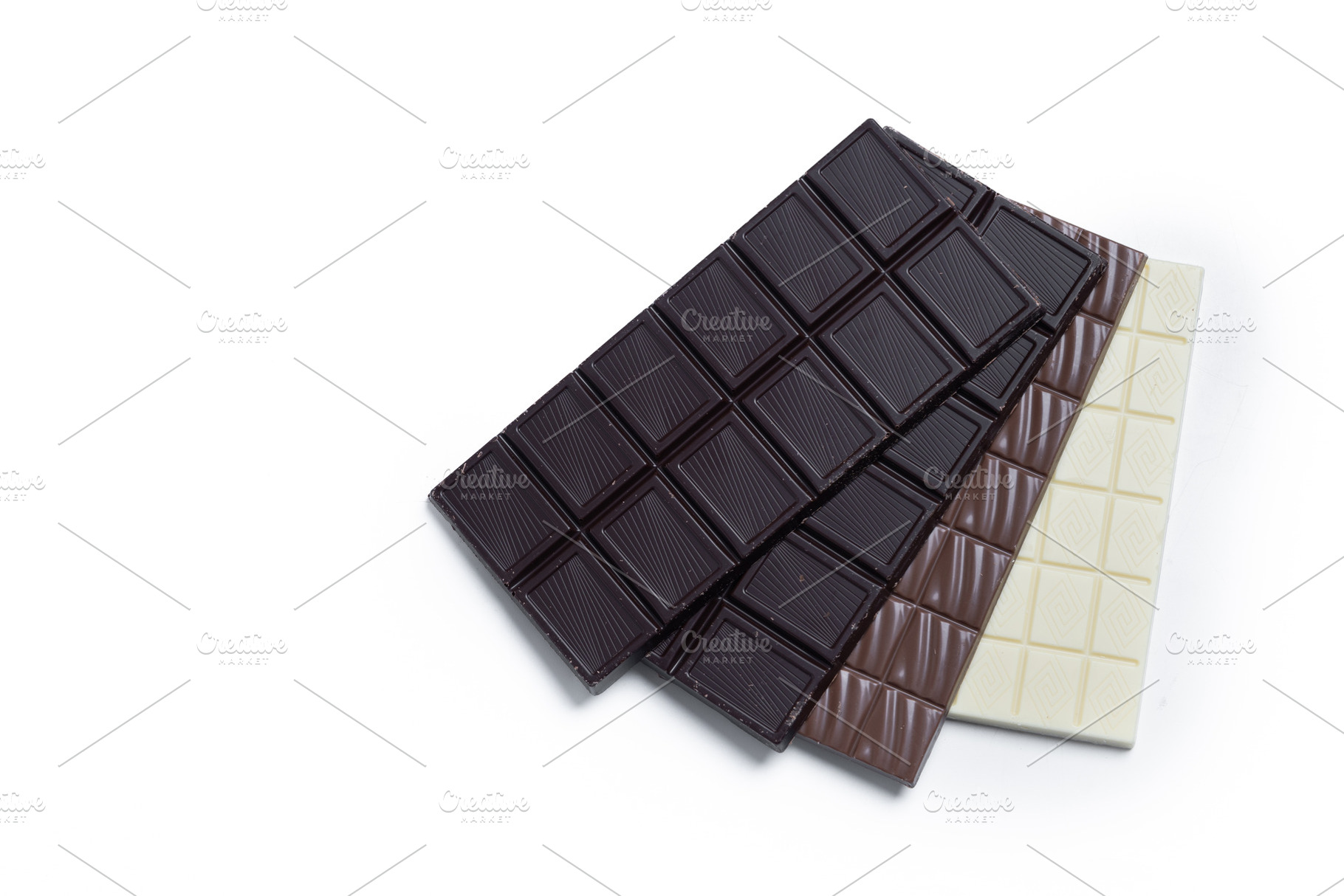 Assortment of white, milk and dark chocolate pieces, a Food & Drink Photo by etorres69