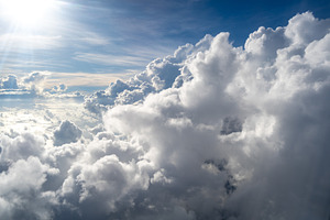 Majestic white clouds and deep blue sky seen from an airplane, a Nature Photo by GoodGoods
