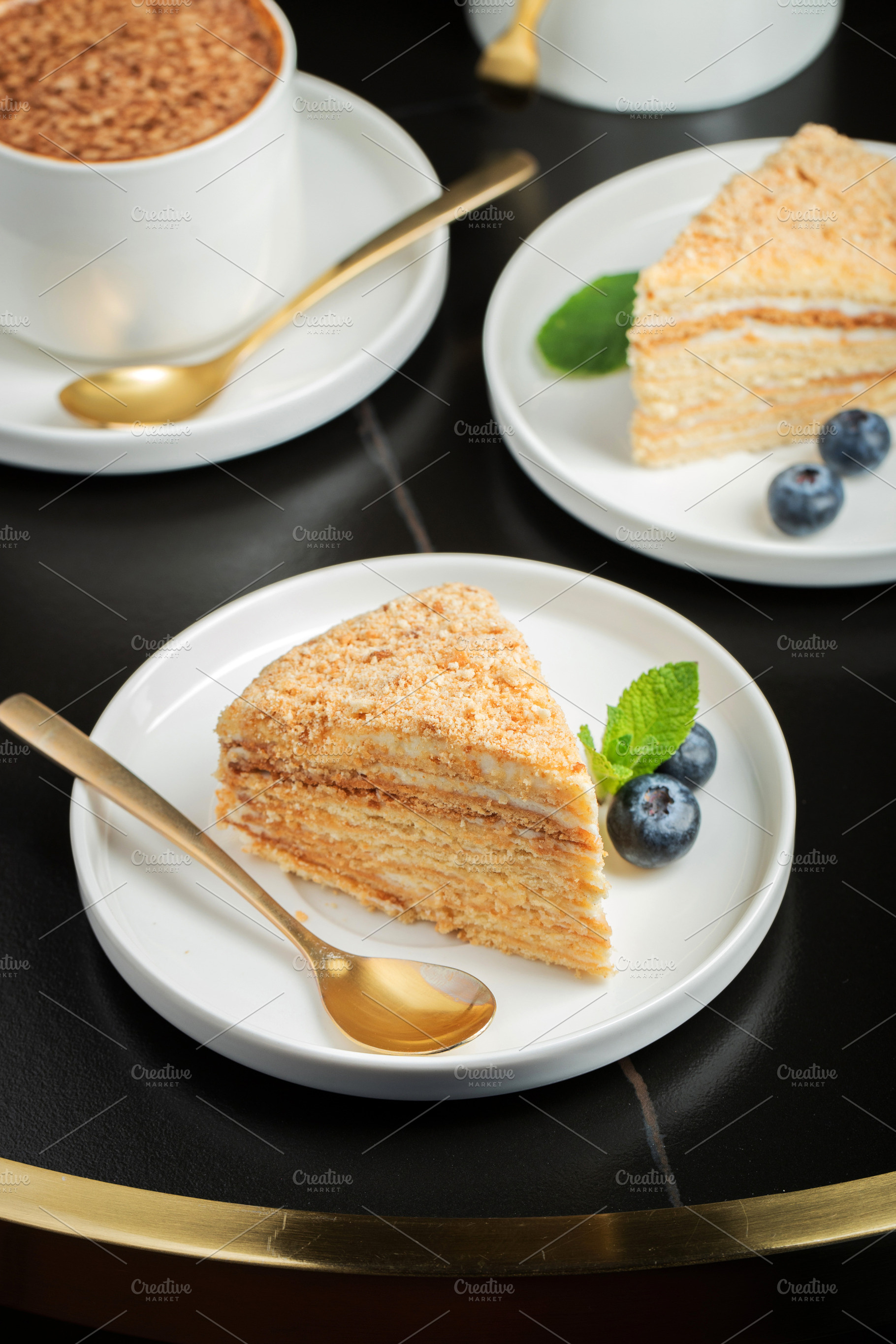 Medovik. Honey cake made from honey cakes with whipped sour cream, decorated wi, a Food & Drink Photo by Budarinphoto