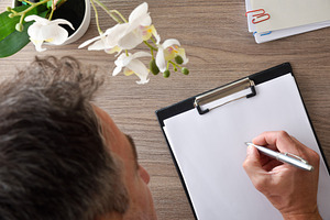 Man Writing on Clipboard at Desk, a Business Photo by Davizro's Market