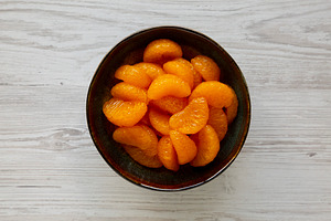 Organic Canned Mandarin Oranges in Bowls, top view. Flat lay, ov, a Food & Drink Photo by LiudmylaChuhunova