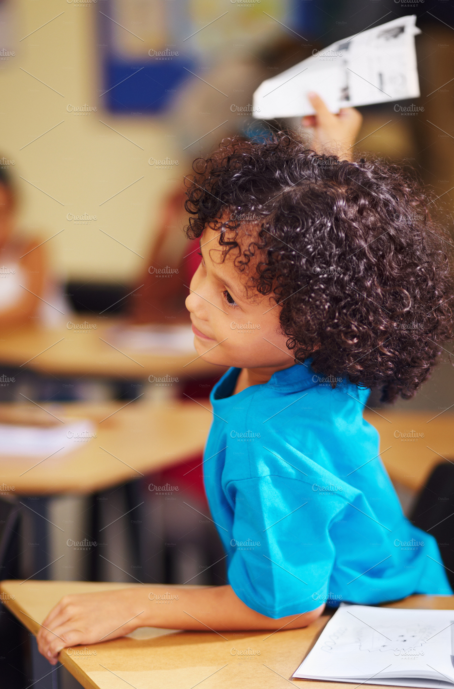 Playing with his homework, a Photo by Peopleimages.com