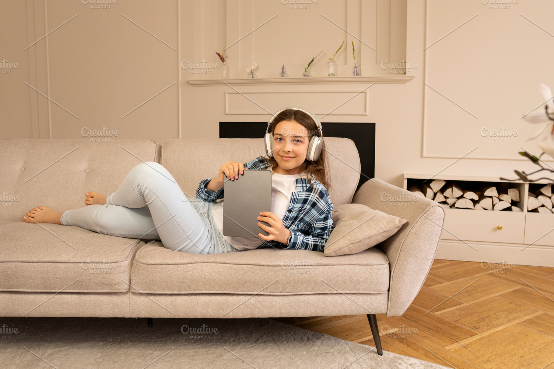 Teenage girl lounging on sofa, a Person Photo by Elena Vagengeim