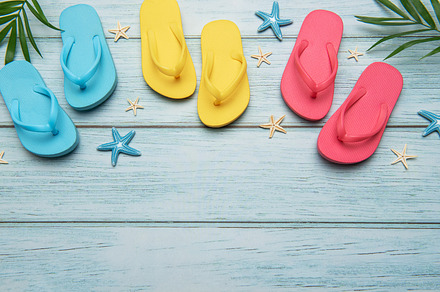 Colorful flip flops and starfish creating summer vacation atmosp