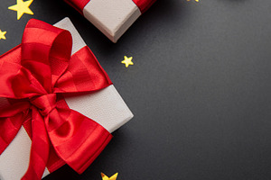 Christmas gifts decorating a dark background with stars, a Holiday Photo by Olena Rudo
