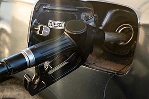 Close-up view of a diesel car being refueled at a gas station, showing fuel noz, a Transportation Photo by Ales Munt