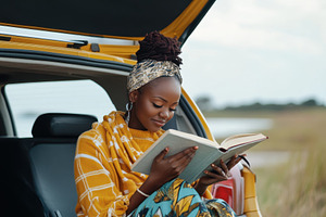 Relaxed african woman enjoys reading, a Photo by Iftikhar Alam