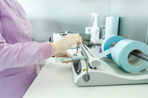 Nurse packing medical instruments for sterilization in a vacuum packing machine, a Health & Medical Photo by Antonio Gravante Market