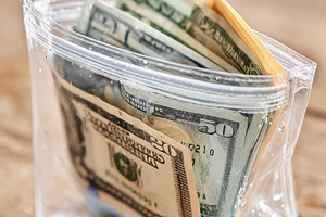 Cash in a clear ziplock bag, a Business Photo by AlyaAnd