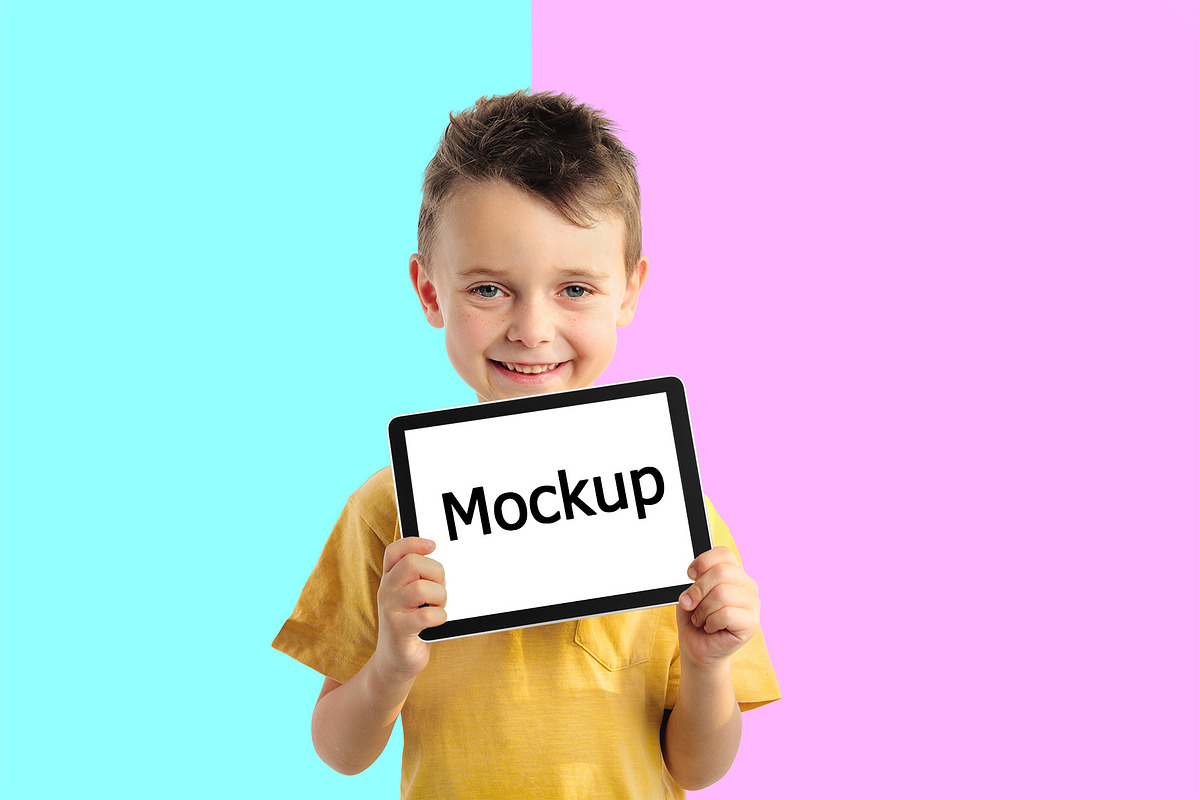 Child holding a tablet, a Books & Magazine Mockup by vovan