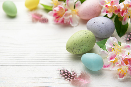 Colorful easter eggs and spring flowers creating festive border, a Holiday Photo by Olena Rudo