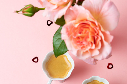Romantic setup with coffee, macarons and roses