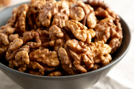 Raw Walnut Halfs in a Bowl, side view. Close-up.