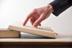 Person reading a book pointing at text with your finger, a School & Education Photo by Davizro's Market