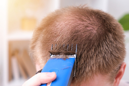 A man cuts his hair with clipper. Cutting a short hairstyle at home. Close-up., a Technology Photo by Detriana