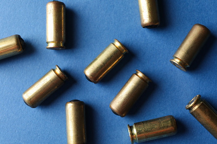 Rubber bullets on blue background, top view. Self defense weapon, an Industrial Photo by AtlasStudio PRO