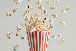 Popcorn flying with striped box, iso, a Food & Drink Photo by Pixeness Studio