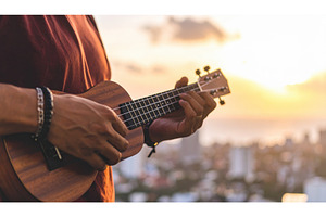 A person playing a ukulele at sunset, a Background Photo by Igor Tichonow