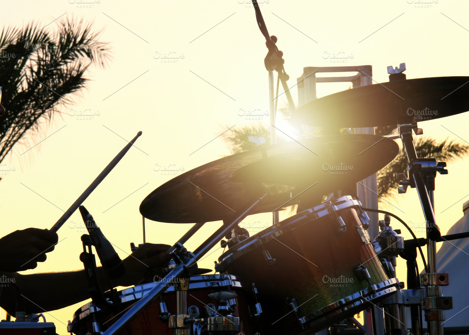 Drummer playing drums during a summer music concert at sunset, an Abstract Photo by Antonio Gravante Market