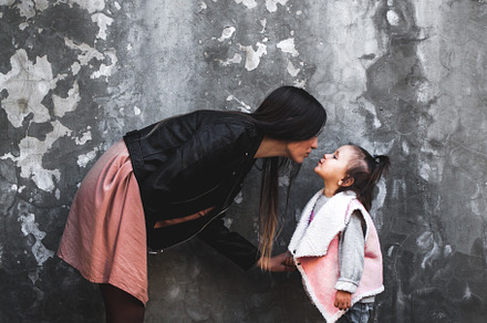 Mom and daughter are kissing