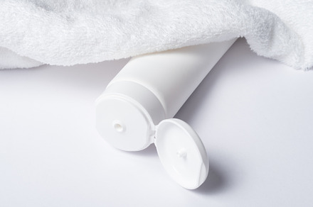 White plastic tube for cosmetic with terry towel, minimalistic c