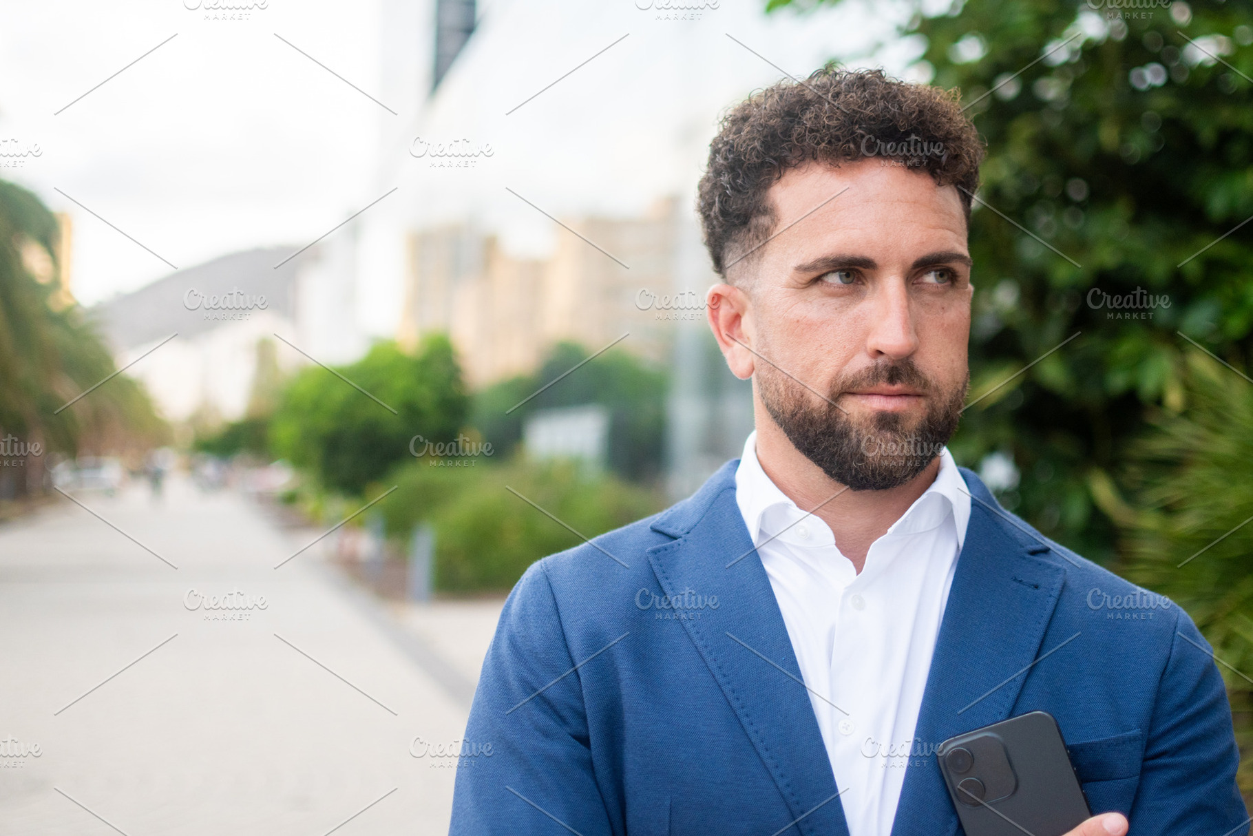 Confident businessman holding smartphone, a Business Photo by etorres69