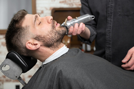 Young hipster Caucasian man during beard grooming in modern barber shop. Men's, a Person Photo by david.herraez.calzad