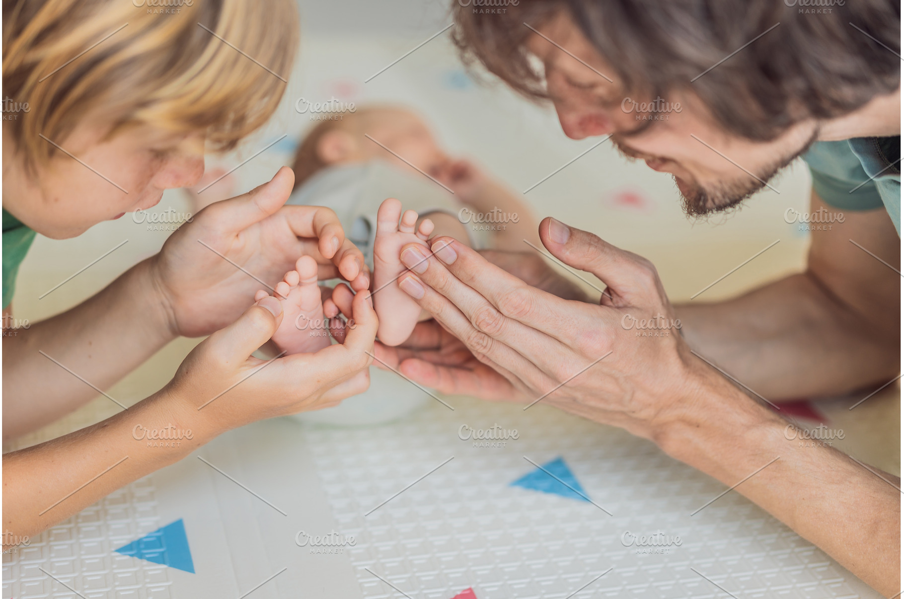 Father, son, and newborn baby lying, a Person Photo by Elizaveta Galitskaya