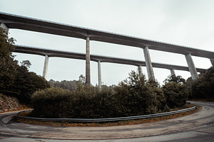 Concrete viaduct above forest road, a Transportation Photo by SkyNext