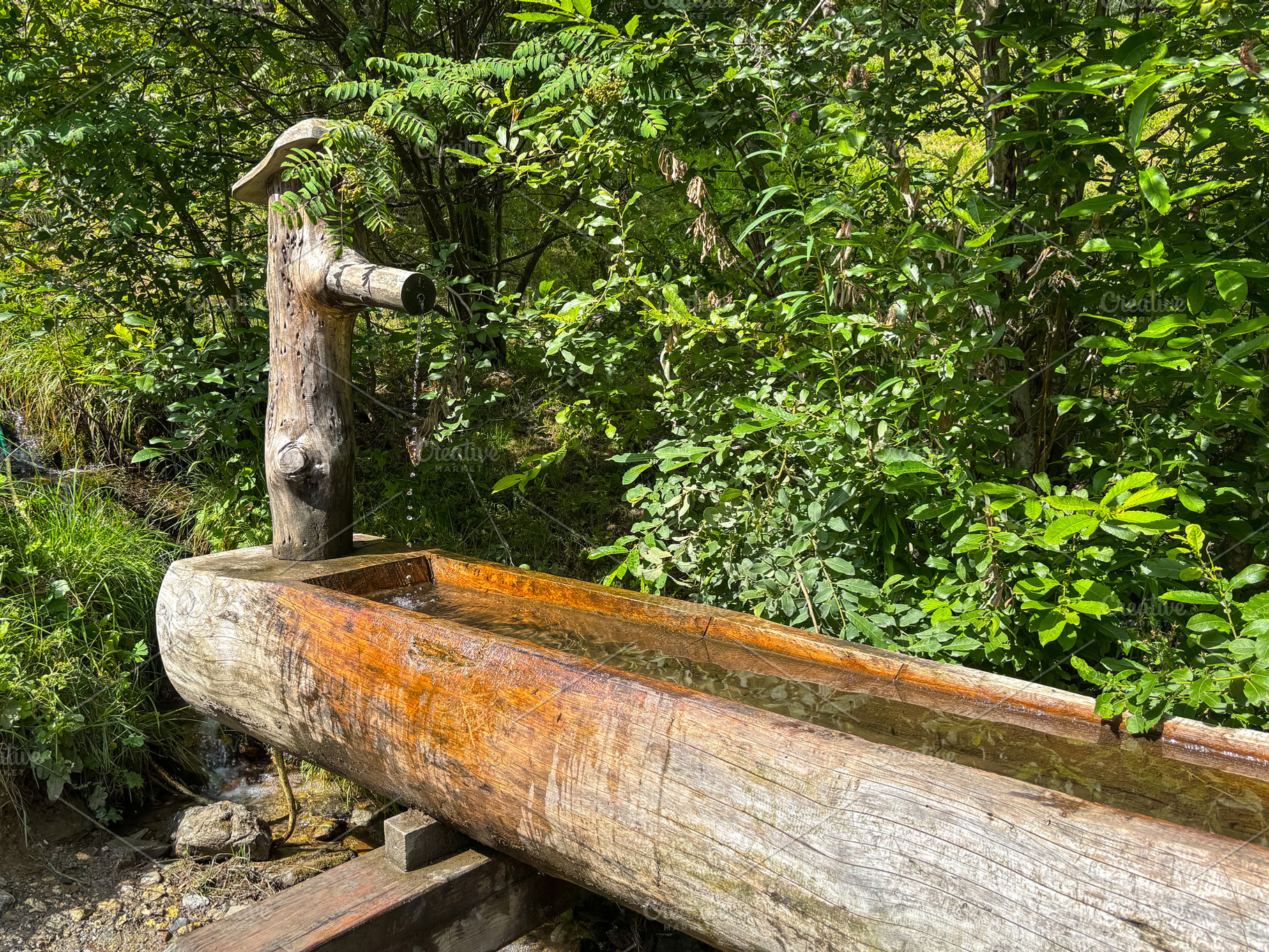 Wooden mountain fountain in forest of Les Contamines-Montjoie, F, an Architecture Photo by GoodGoods