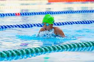 Swimmer child swims breaststroke swimming style in a race swimmi