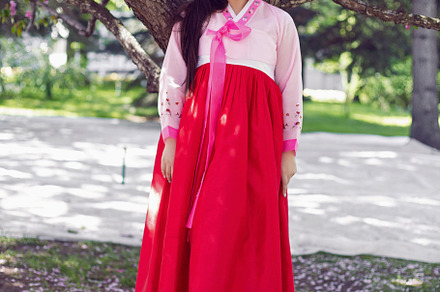portrait young woman a Korean bride in national costumes stand by cherry blosso, a Person Photo by SaulichPhoto