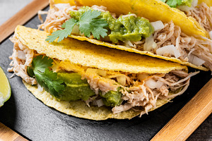 Mexican chicken tacos with guacamole and cilantro