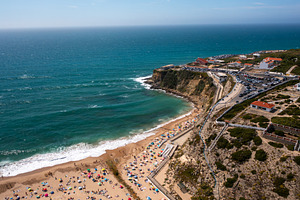 Drone view of scenic Magoito Beach with town on cliffs during daytime, a Photo by andreonegin market