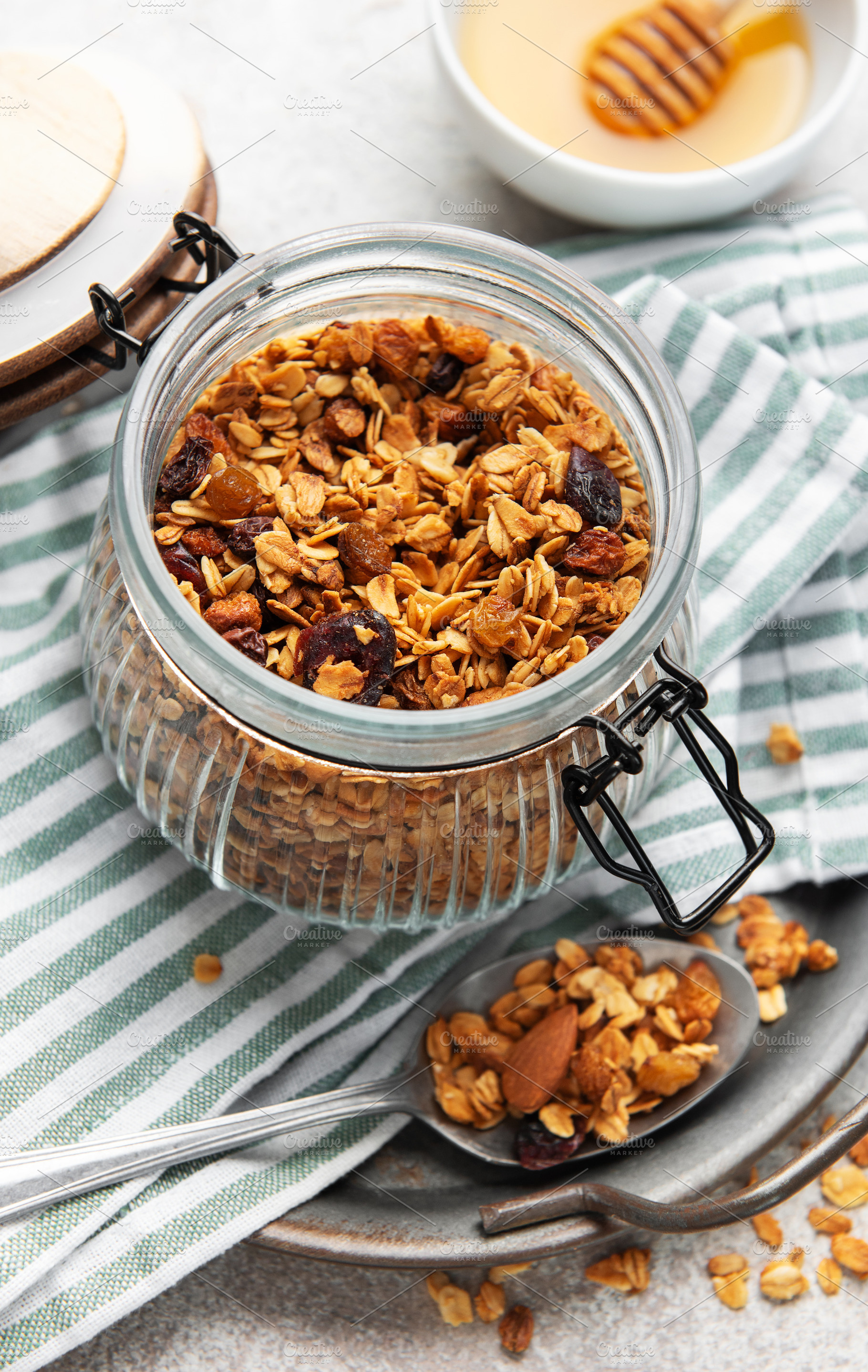 Healthy homemade granola breakfast cereal in glass jar, a Food & Drink Photo by Olena Rudo