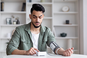 Young Arab Man Checking Blood Pressure With Modern Tonometer At Home, a Photo by Prostock-Studio