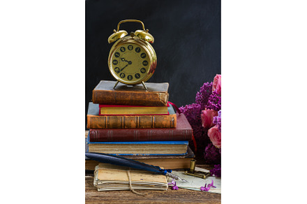 pile of books with clock, a School & Education Photo by Neirfy
