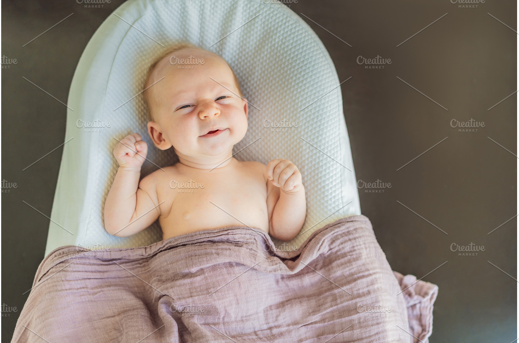 Newborn baby comfortably resting in, a Health & Medical Photo by Elizaveta Galitskaya