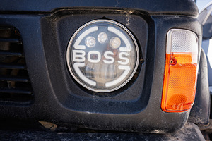 Front grilles and headlight of a vehicle captured in close-up view, a Photo by AS photostudio