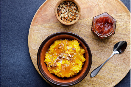 Sweet pumpkin porridge in clay bowl, a Food & Drink Photo by serkum