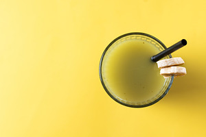 Green smoothie with banana, apple, and lemon on yellow background, a Food & Drink Photo by etorres69