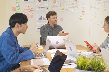 A group of multi ethnic business team talk, communicate, discuss, a Photo by Tampatra