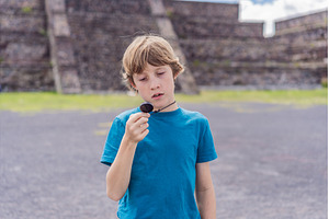 Boy tourist holding and observing a, an Architecture Photo by Elizaveta Galitskaya