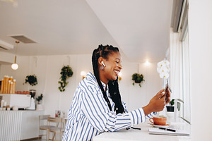 Cheerful young businesswoman having a video call on a smartphone, a Person Photo by Jacob Lund