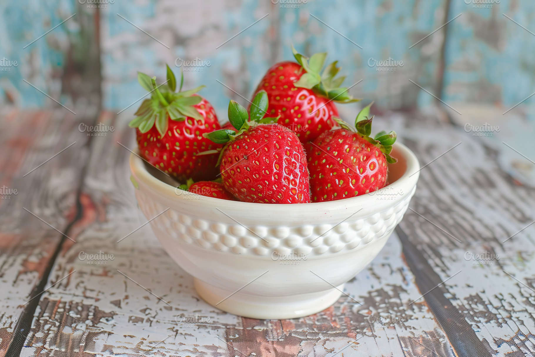 Red strawberries in bowl on wooden table, a Food & Drink Photo by AlyaAnd